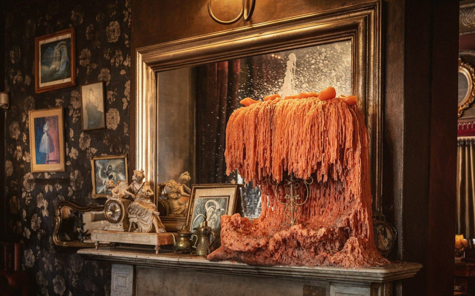 A mantelpiece of mismatched accumulated objects